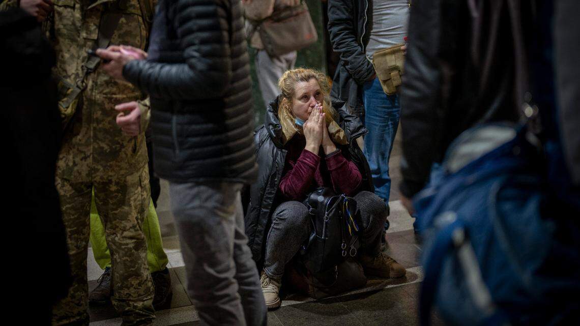A woman reacts Thursday as she waits for a train trying to leave Kyiv, Ukraine. An invasion by Russian troops into Ukraine has heightened tensions around the world and caused many residents of Kyiv to flee the city.