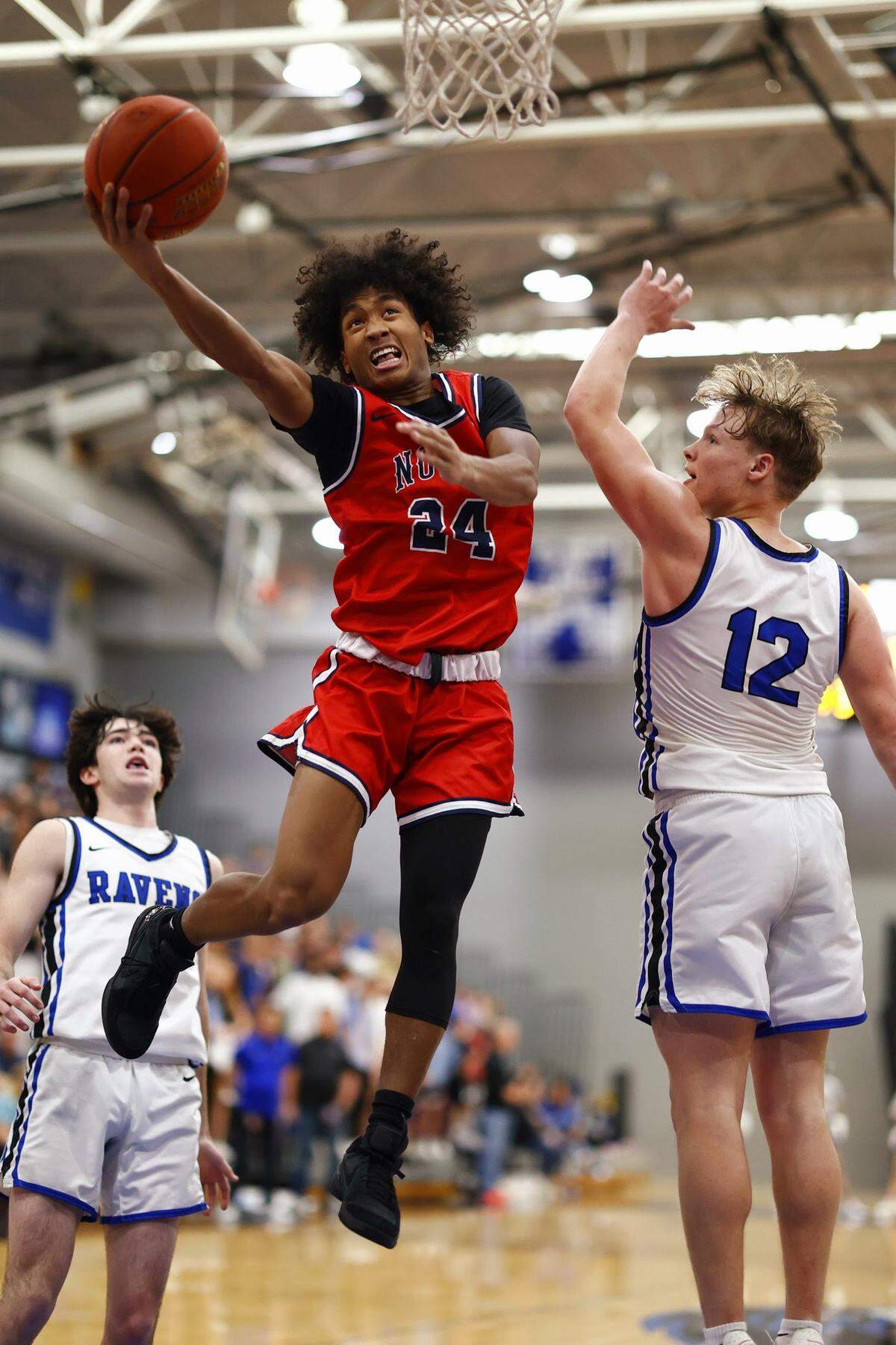 Olathe North’s Jaalan Watson drives to the bucket.