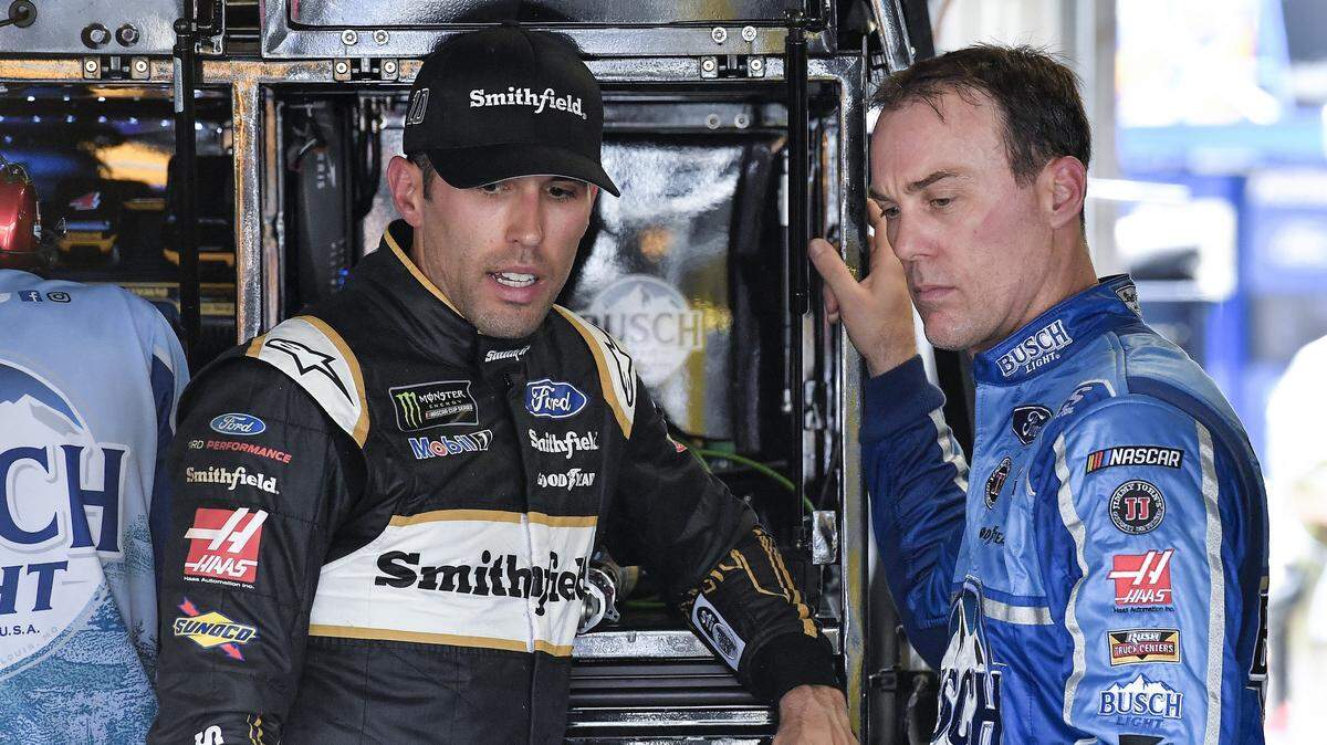 Drivers Aric Almirola, left, and Kevin Harvick strategize during Friday's Monster Energy NASCAR Cup Series practice at Kansas Speedway.