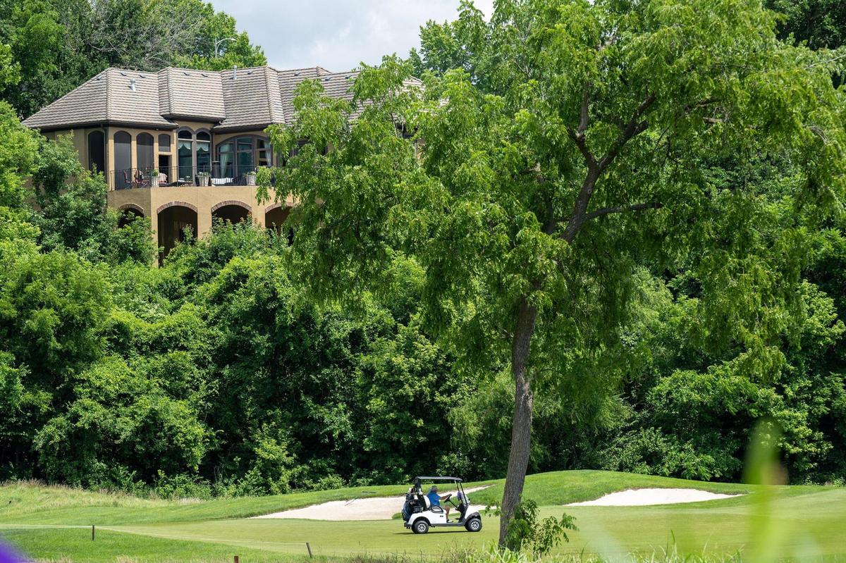 Large homes are perched above the Tom Watson-designed championship golf course at The National Golf Club of Kansas City on Tuesday, July 8, 2025, in Parkville, Missouri.