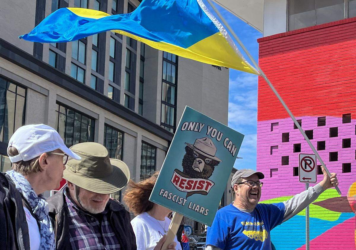 Protesters marched along Broadway Boulevard near the Country Club Plaza on Saturday, March 28, 2026, for a No Kings protest against the Trump administration in Kansas City.