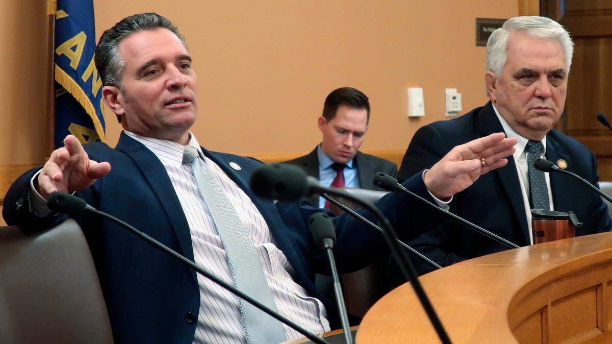 Kansas Senate President Ty Masterson, left, R-Andover, makes a point during a meeting of GOP senators as Majority Leader Larry Alley, right, R-Winfield, watches, Monday, Nov. 22, 2021, at the Statehouse in Topeka, Kan. Masterson is pushing a proposal to provide unemployment benefits to workers who lose their jobs because they refuse to get vaccinated against COVID-19. (AP Photo/John Hanna)