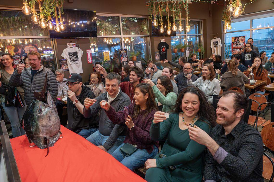 Guests toast Kubota sake during the bluefin tuna cutting show at KC Craft Ramen on Monday, March 2, 2026, in Overland Park.