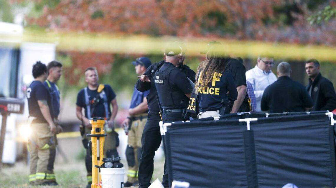 Broken Arrow, Okla., police and fire department investigate the scene of a fire with multiple fatalities at the corner South Hickory Ave. and West Galveston St. on Thursday, Oct. 27, 2022. Eight people were found dead Thursday after a fire was extinguished at a Tulsa-area house, and police said they were investigating the deaths as homicides.