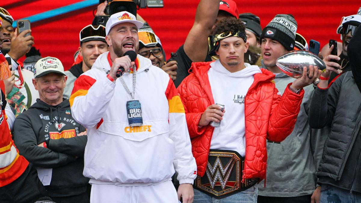 Kansas City Chiefs tight end Travis Kelce addresses the crowd as quarterback Patrick Mahomes and teammates looked on at Union Station for the Super Bowl Champions parade and rally on Wednesday, Feb. 15, 2023, in Kansas City.