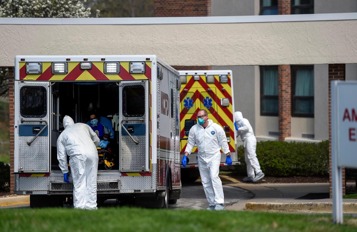 Medics from Kansas City Fire Department donned protective suits Tuesday before unloading two patients at Riverbend Post Acute Rehabilitation in Kansas City, Kansas. It is unknown if these two patients were COVID-19 patients.