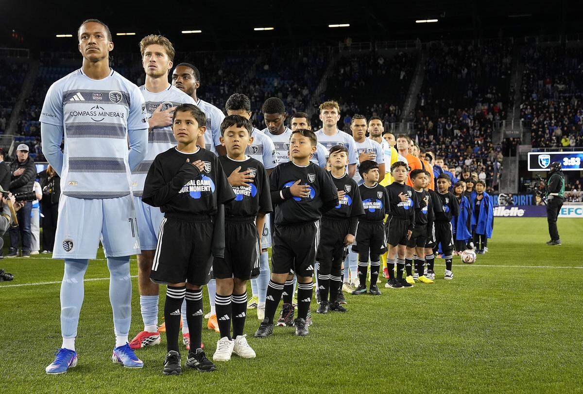 Sporting Kansas City players stand for pre-game festivities on opening night for Major League Soccer at San Jose, Calif., where the team from KC lost to the host Earthquakes.