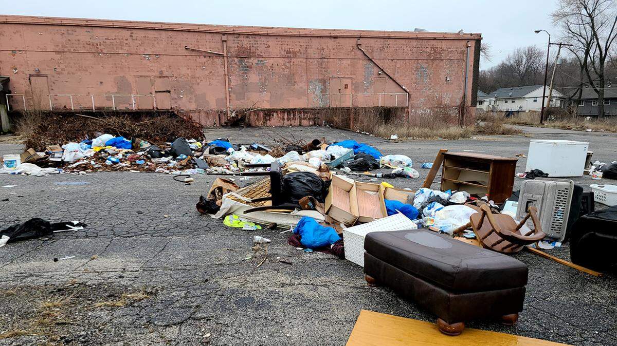 Trash litters the area behind the Robandee Shopping Center, and the people who live nearby are tired of waiting for the city to act.