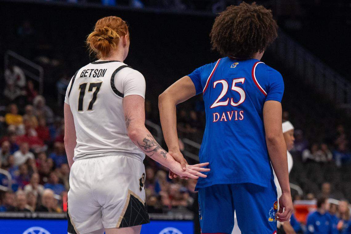 Kansas Jayhawks forward Jaliya Davis (25) swats away the hand of Colorado Buffaloes forward Tabitha Betson in the first half of KU’s second-round game at the Big 12 Women's Basketball Tournament on Thursday, March 5, 2026, at T-Mobile Center in Kansas City.