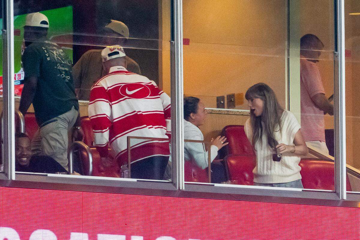 Travis Kelce and Taylor Swift exit the suites at the end of the game between the Cincinnati Bearcats and the Nebraska Cornhuskers an at GEHA Field at Arrowhead Stadium. 