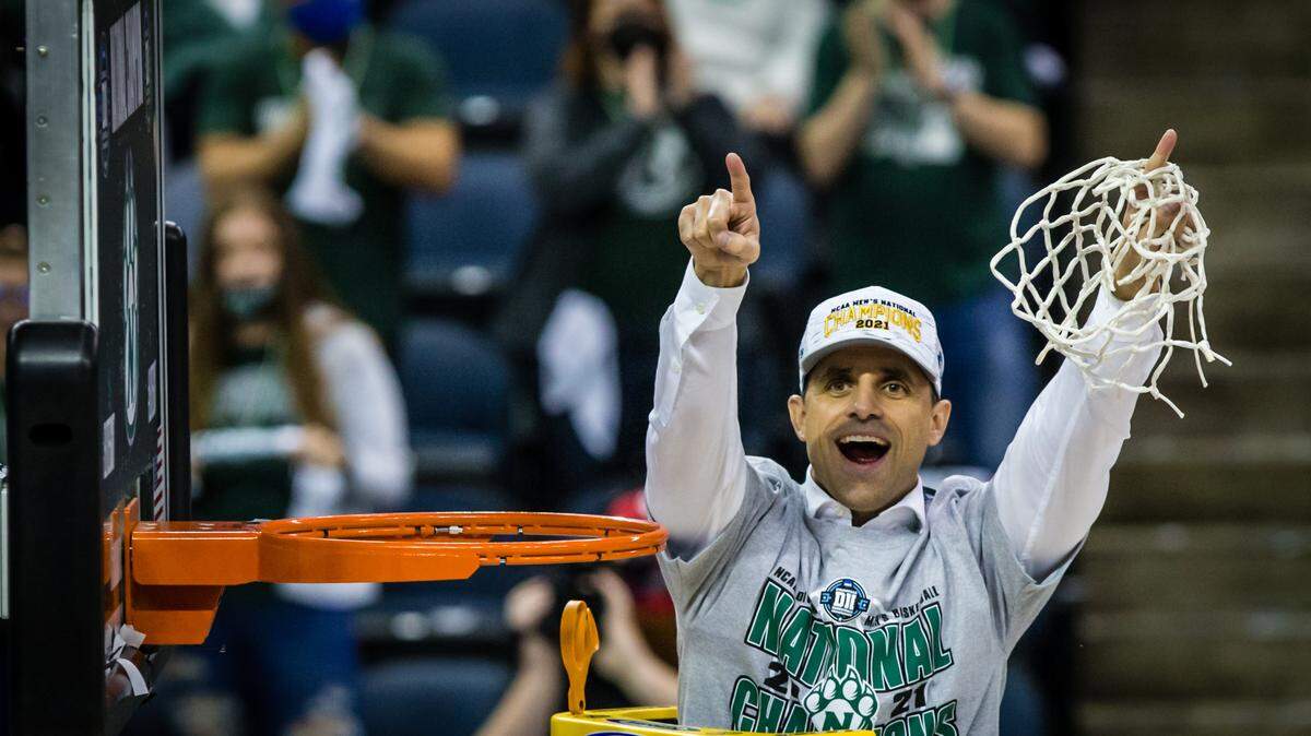 Northwest Missouri State coach Ben McCollum cuts down the net following Saturday afternoon’s victory over West Texas A&M in the NCAA Division II championship game at the Ford Center in Evansville, Ind.
