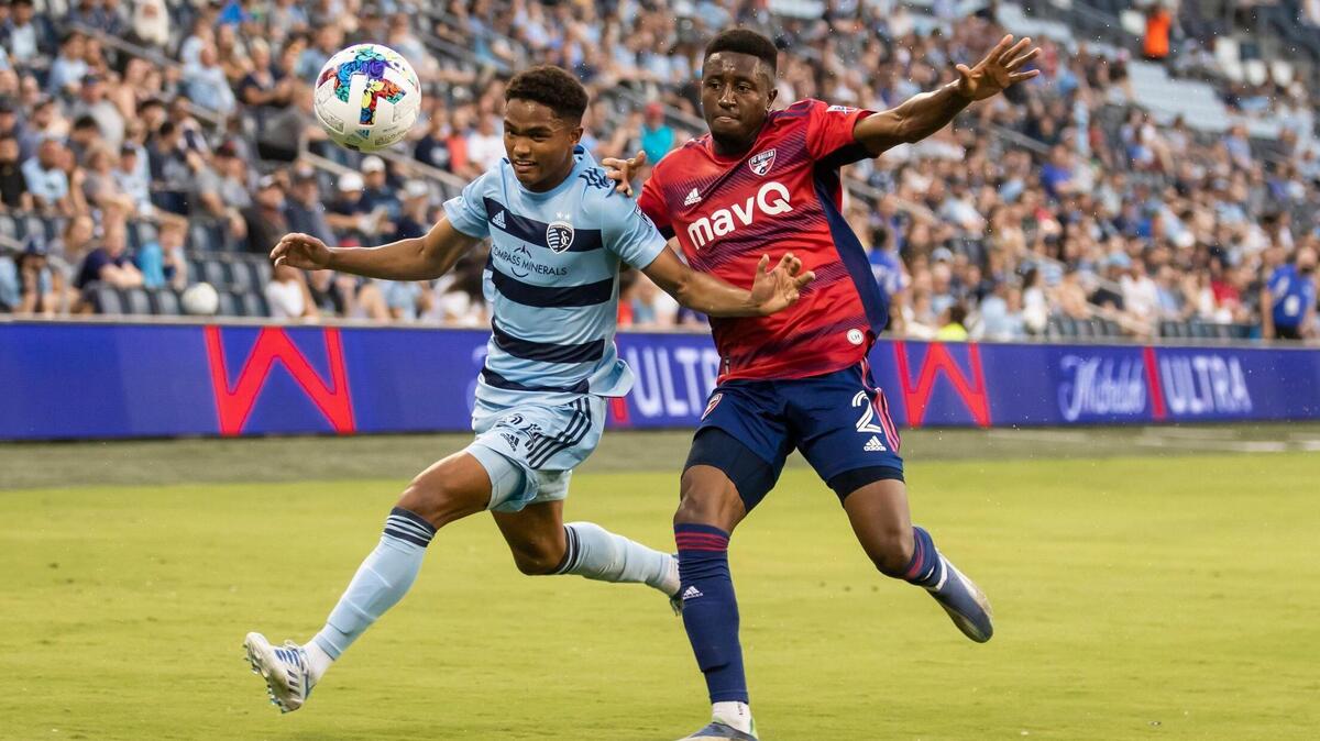 Sporting Kansas City defender Kayden Pierre (left) shields off FC Dallas defender Eddie Munjoma during a U.S. Open Cup match earlier this year at Children’s Mercy Park in Kansas City, Kansas.