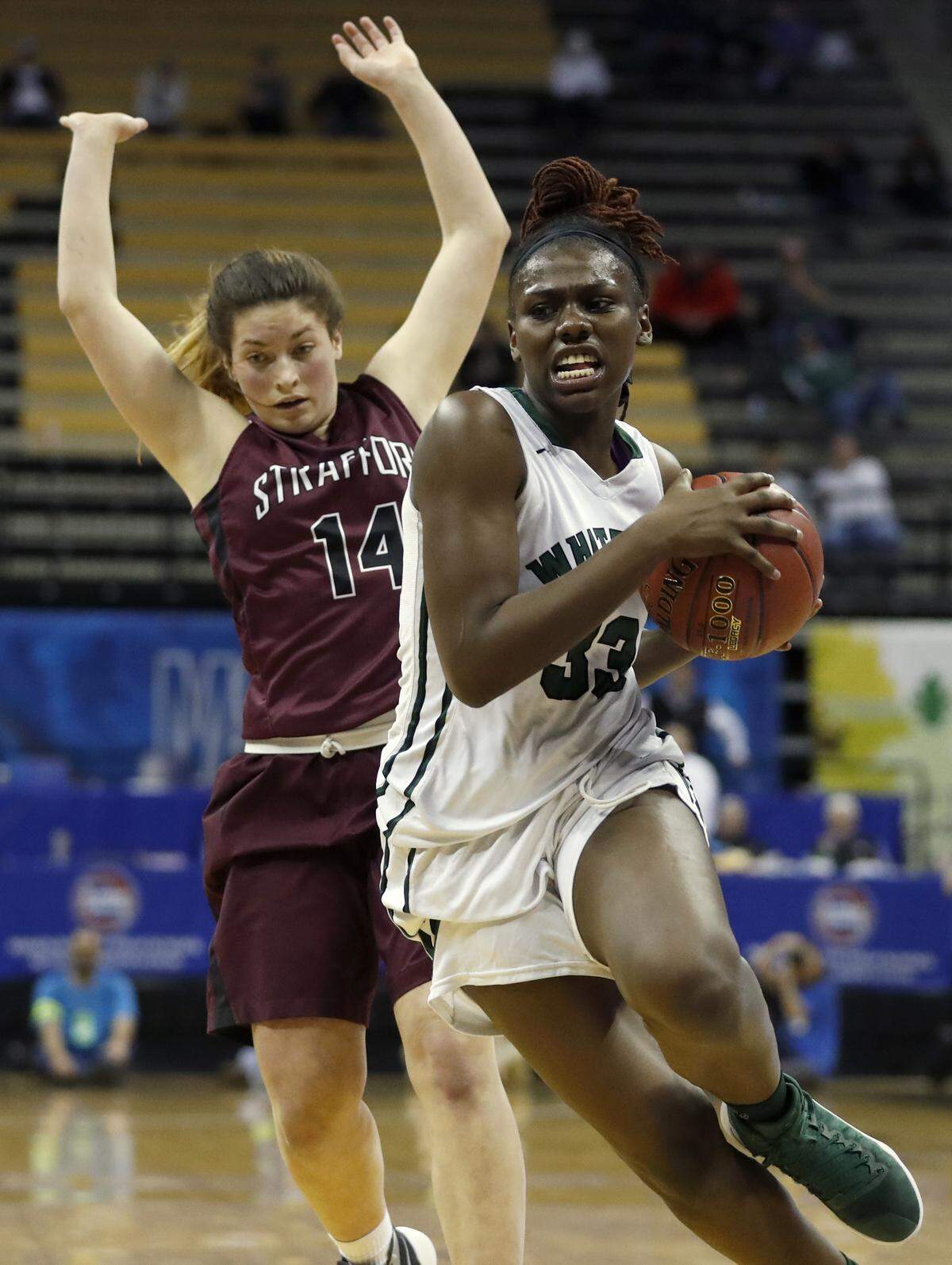 Whitfield’s Aijha Blackwell, right, heads to the basket past Strafford’s Mica Chadwell during the second half of the Missouri Class 3 girls high school championship basketball game Saturday, March 11, 2017, in Columbia, Mo. Strafford won 80-39. (AP Photo/Jeff Roberson)