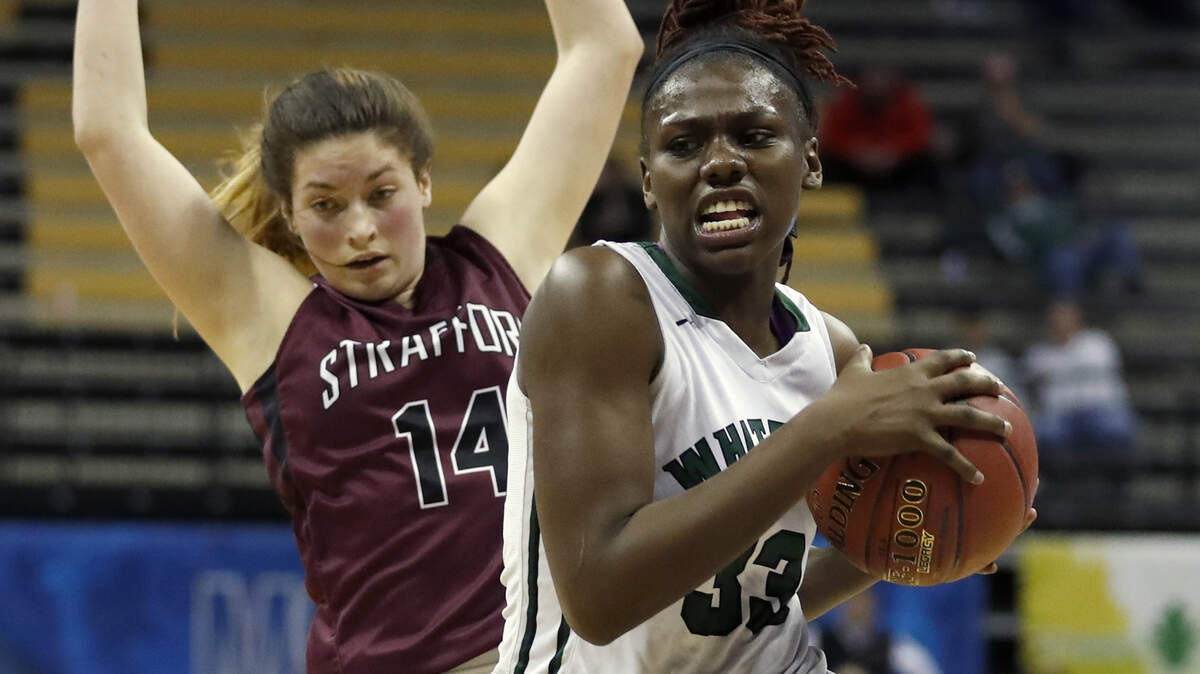 Whitfield’s Aijha Blackwell, right, heads to the basket past Strafford’s Mica Chadwell during the second half of the Missouri Class 3 girls high school championship basketball game Saturday, March 11, 2017, in Columbia, Mo. Strafford won 80-39. (AP Photo/Jeff Roberson)