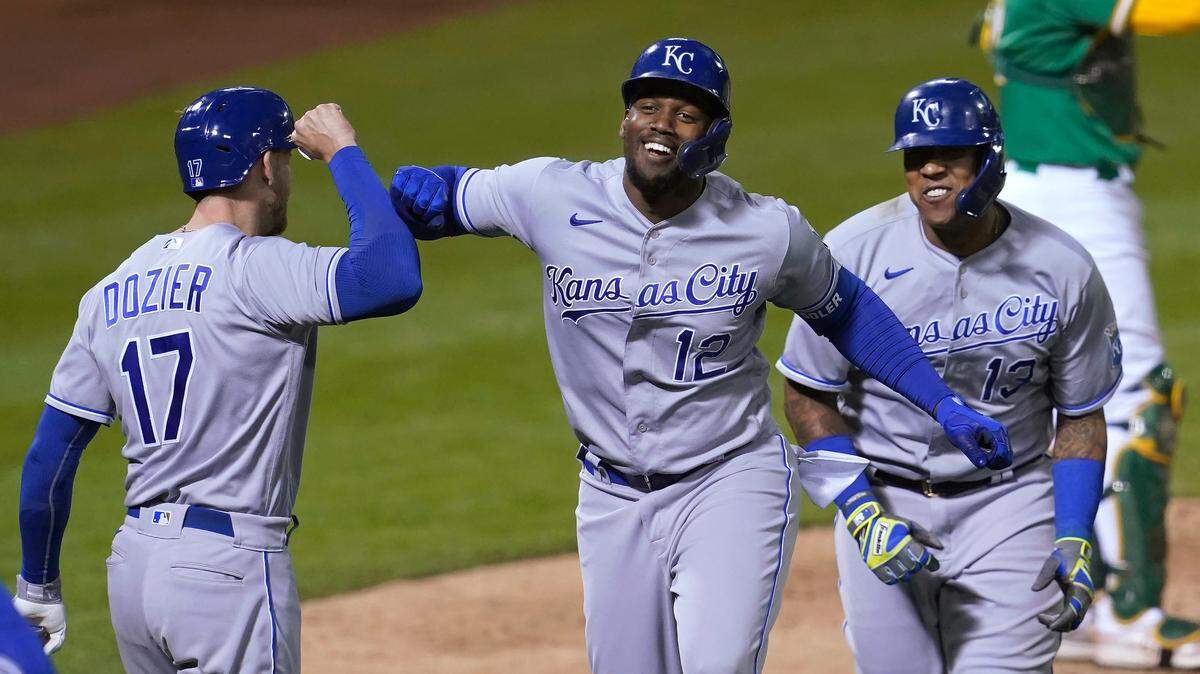 The Royals’ Jorge Soler (center) is congratulated by Hunter Dozier (left) after hitting a two-run home run that scored Salvador Perez (right) during the eighth inning against the Oakland Athletics in Oakland, Calif., Thursday, June 10, 2021.