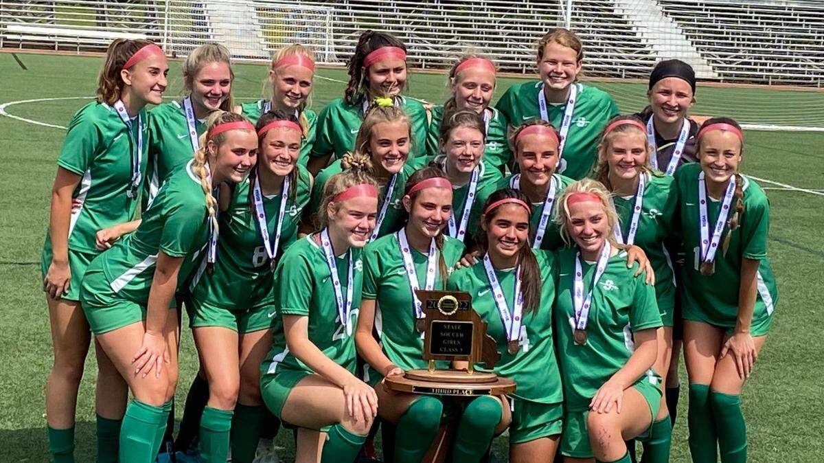 Members of the Smithville High School girls soccer team pose with their third-place trophy after ending their state-tournament run with a victory on Saturday in Fenton.
