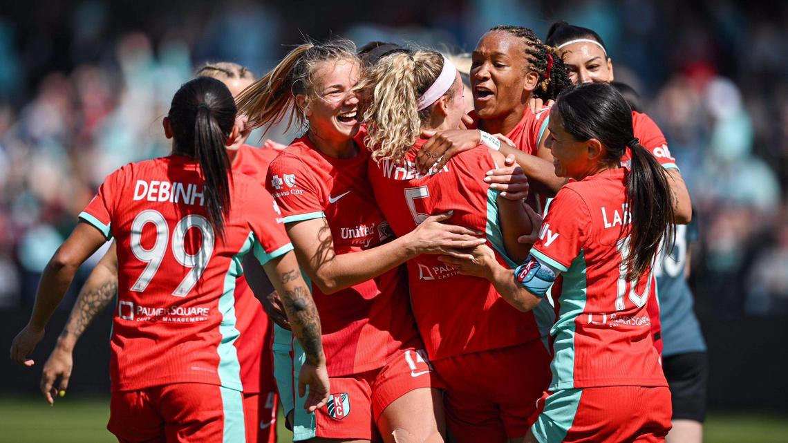 Kansas City Current defender Ellie Wheeler (5) is mobbed by teammates after scoring a goal against the Portland Thorns during the home opener for the Current Saturday, March 16, 2024 at CPKC Stadium.