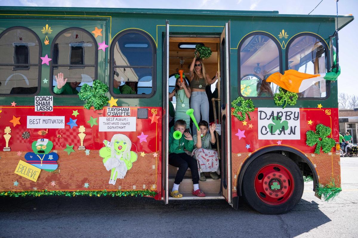 The Darby Clan ride a bus in the parade at the Kansas City St. Patrick’s Day Parade on Monday, March 17, 2025.
