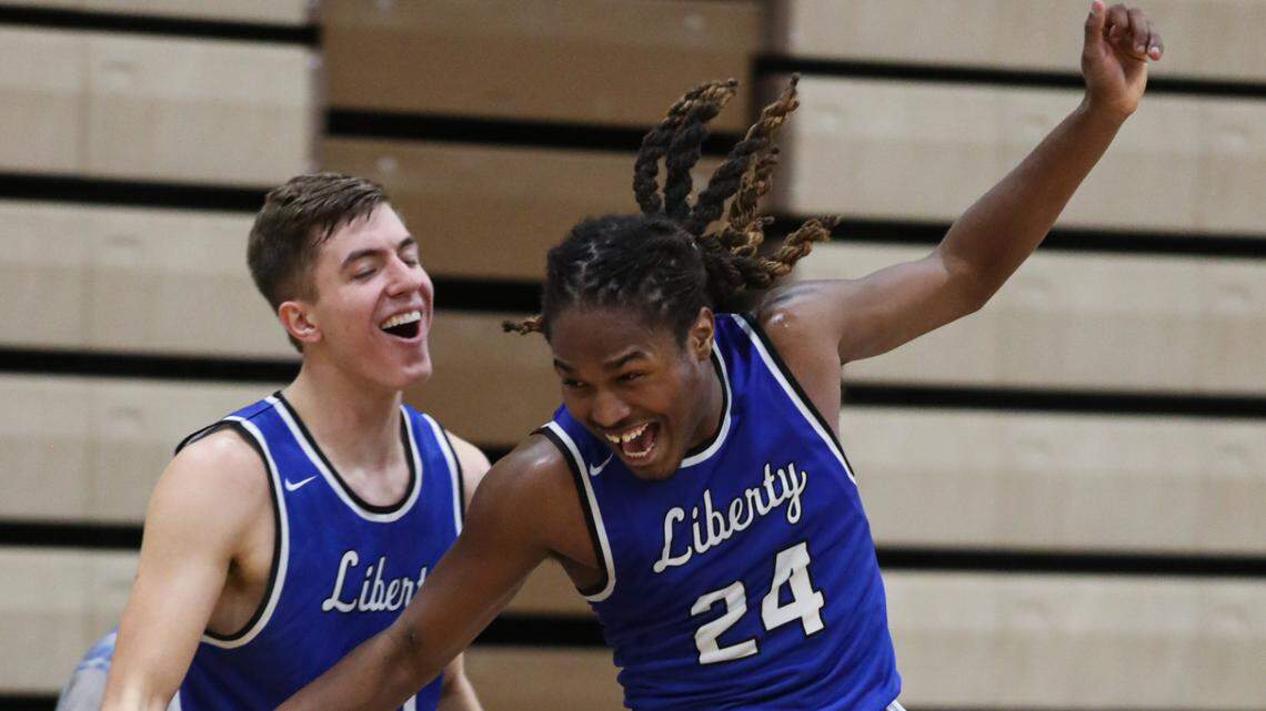 Javin Shaw, left, and Kellen Goodwin celebrate during Liberty’s 53-27 win Friday night at Raymore-Peculiar. Shaw scored 17 to lead the Blue Jays over the Panthers.