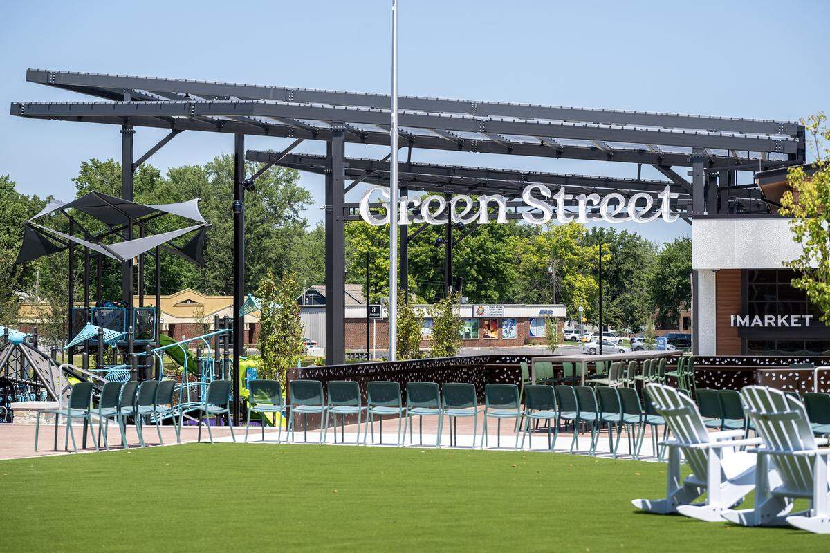Chairs line a green space near the playground and market entrance at the Green Street development on Tuesday, Aug. 5, 2025, in Lee's Summit.