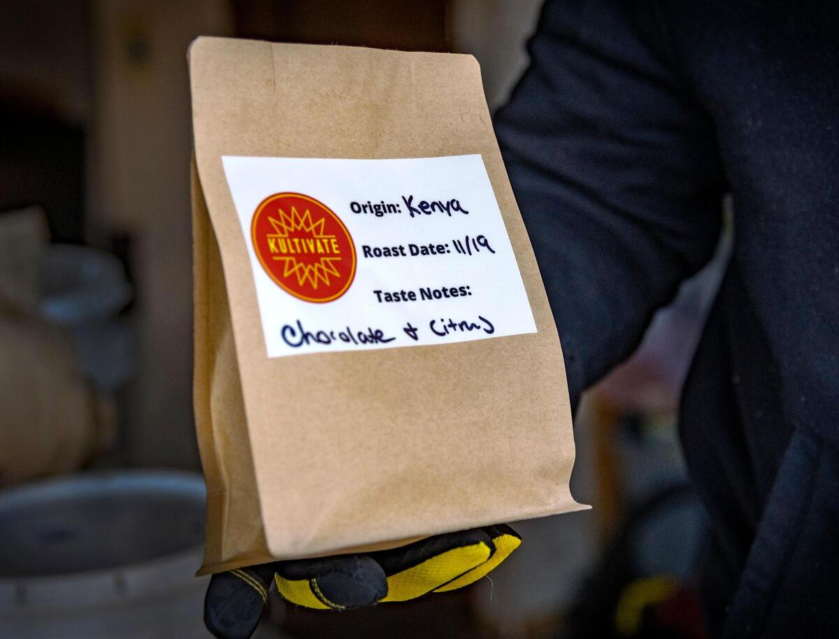 Brent Rice’s Kultivate roasted coffee beans are packaged in brown bags to be sold to customers.