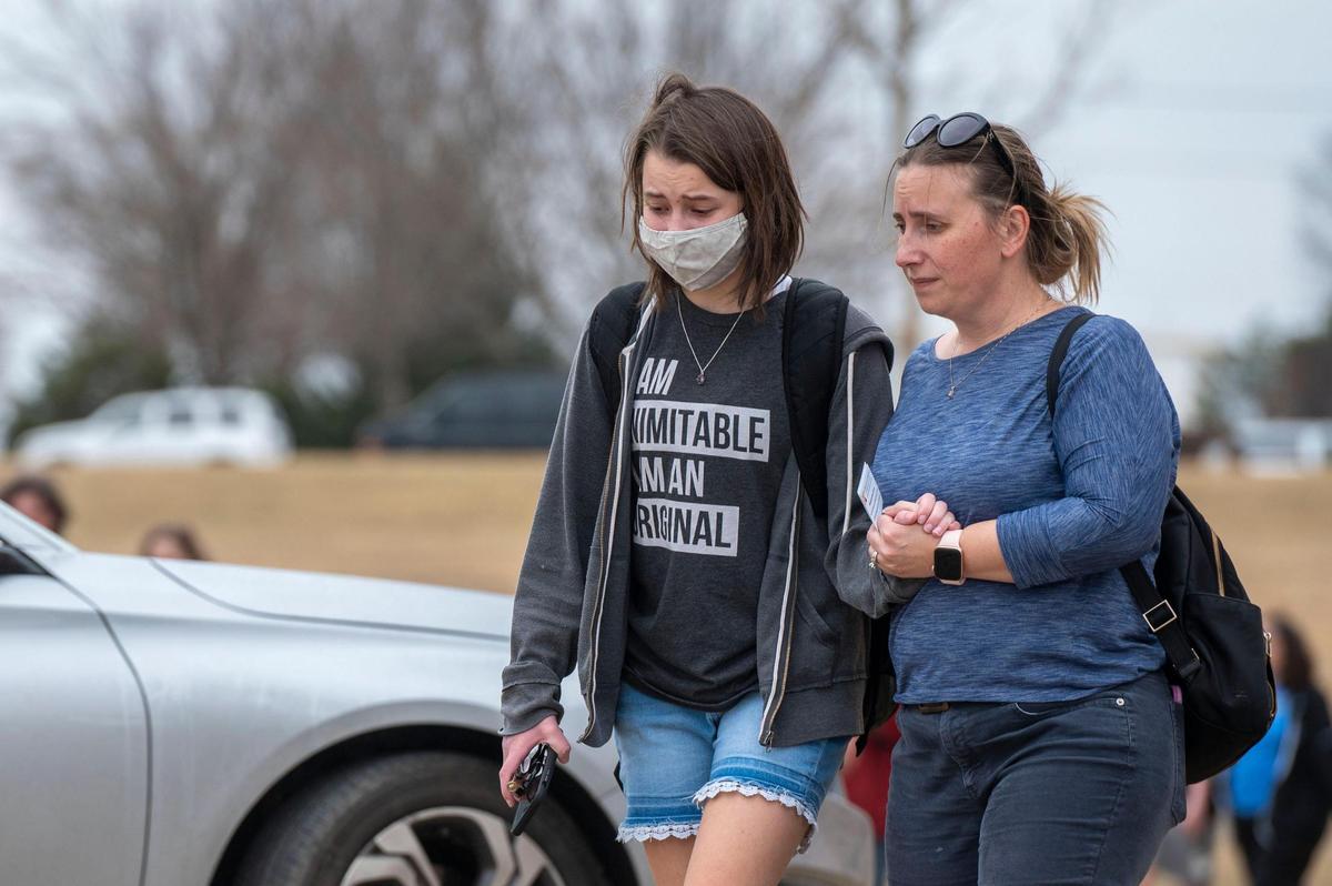 Parents reunite with their children outside California Trail Middle School on Friday, March 4, 2022. Parents were able to pick up their children at the middle school after reports of a shooting that took place at Olathe East High School earlier that morning.