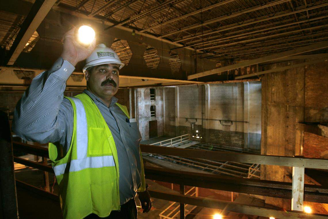 In 2006, a construction manager looked at the interior structure of the Mainstreet Theater. Patrons waited three years until the six-screen theater was finished. The old stage is in the background, center.