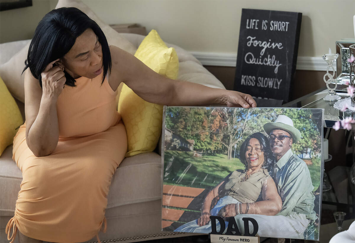 Diahna Carroll looks at a photo of her and her late husband, Alphonso “Duke” Carroll, on Thursday, Aug. 14, 2025, at her home in Lee’s Summit. “I lost part of me,” said Carroll, who added that the couple had “an awesome marriage, and an awesome union.”  Alphonso “Duke” Carroll, was killed on Jan. 2, 2024, when a robbery suspect fleeing police hit his vehicle while driving the wrong way on Interstate 435. 