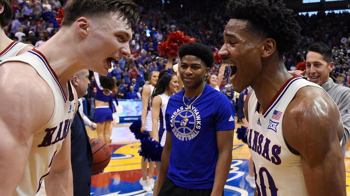 KU teammates Christian Braun (left) and Ochai Agbaji celebrate the Jayhawks’ 70-63 overtime win over Texas Saturday at Allen Fieldhouse (March 5, 2022).