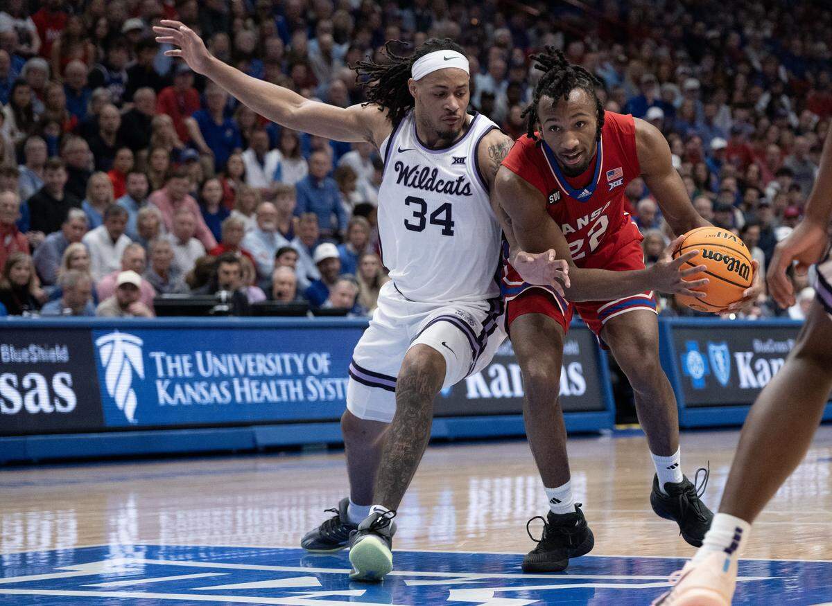 Kansas Jayhawks guard Darryn Peterson (22) drives as Kansas State Wildcats guard Nate Johnson (34) defends in the second half at Allen Fieldhouse on Saturday, March 7, 2026, in Lawrence, Kansas.