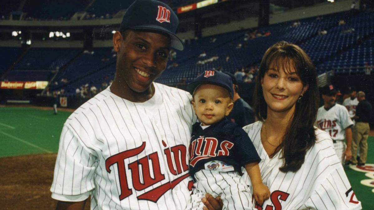 Patrick Mahomes as a baby when his dad was playing for the Minnesota Twins. At right is is mom, Randi.