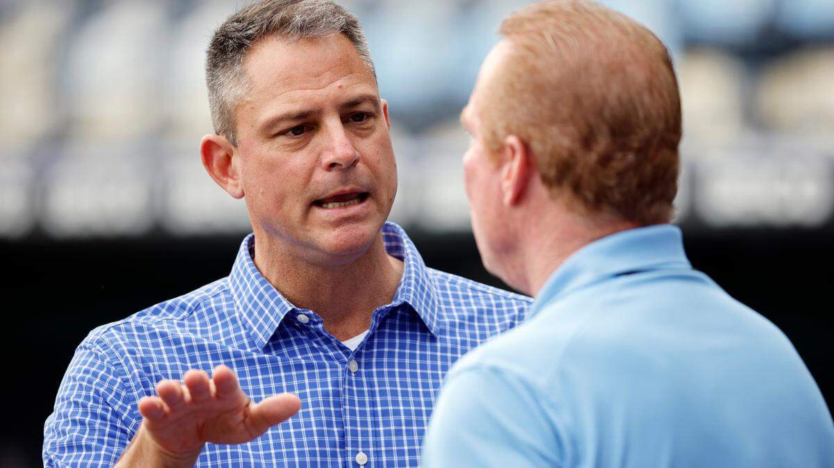 Kansas City Royals General Manager J.J. Picollo, left, talks with Royals’ TV broadcaster Rex Hudler, right, during batting practice before a baseball game against the Houston Astros in Kansas City, Mo., Saturday, June 4, 2022. (AP Photo/Colin E. Braley)