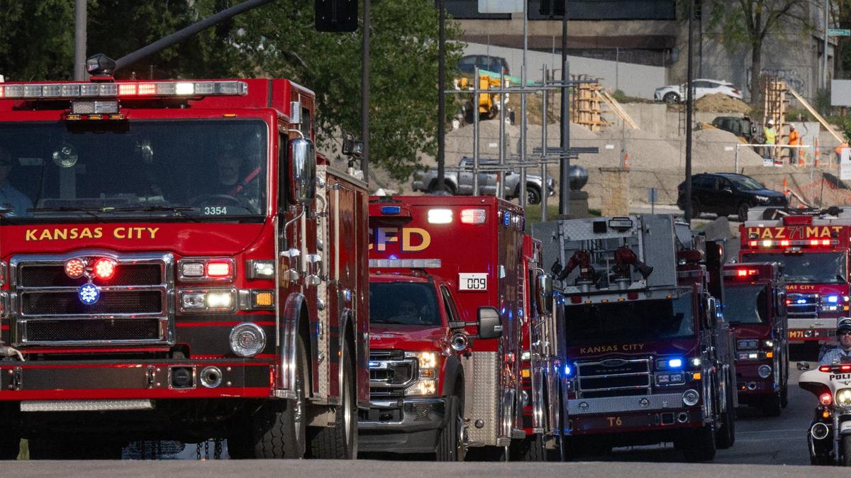 A procession of Kansas City Fire Department trucks