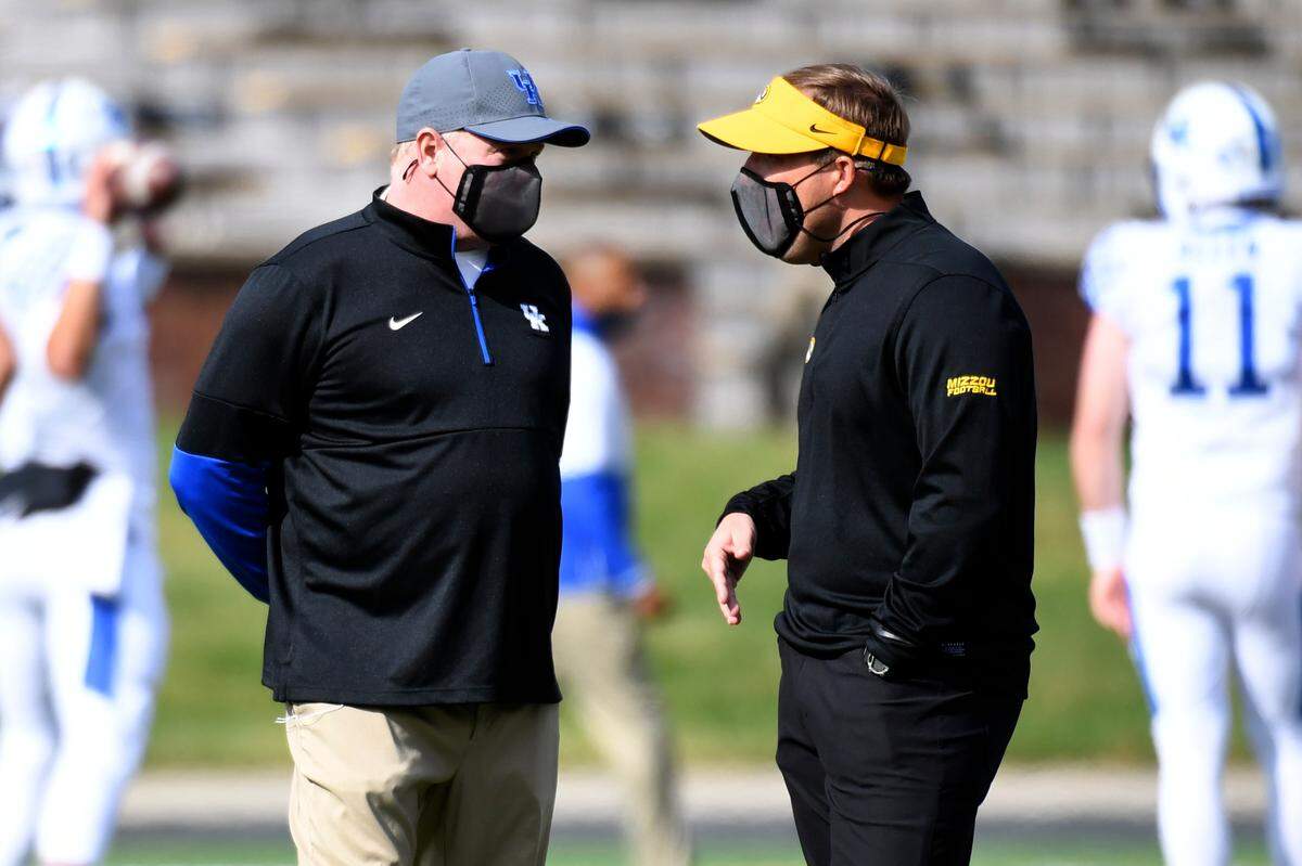Kentucky Coach Mark Stoops, left, spoke with Missouri head man Eli Drinkwitz before the Wildcats and Tigers faced off in Columbia in 2020. Mizzou won that game 20-10, its only victory over Kentucky in the last seven meetings between the two.