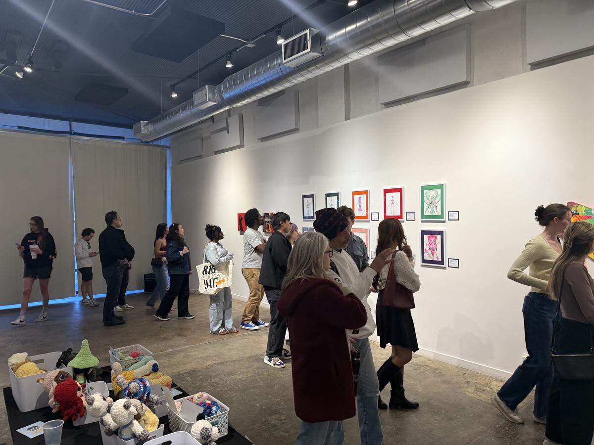 Visitors view the art at ArtsKC during It’s Giving: Kansas City Queerness’s exhibit in Kansas City, Missouri.