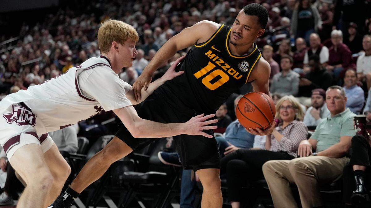 Missouri guard Nick Honor (No. 10) is pressured by Texas A&M guard Hayden Hefner during Wednesday night’s SEC hoops game in College Station, Texas.