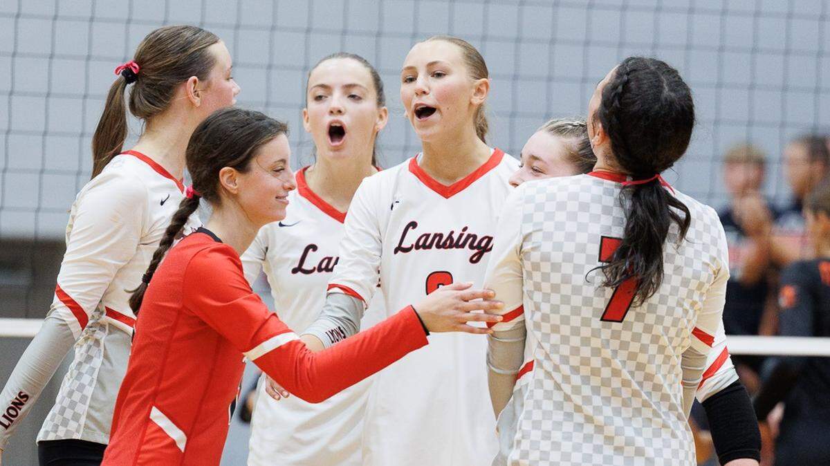 The Lansing High volleyball team celebrates a win against Shawnee Mission Northwest during last weekend’s St. James Academy Slam.