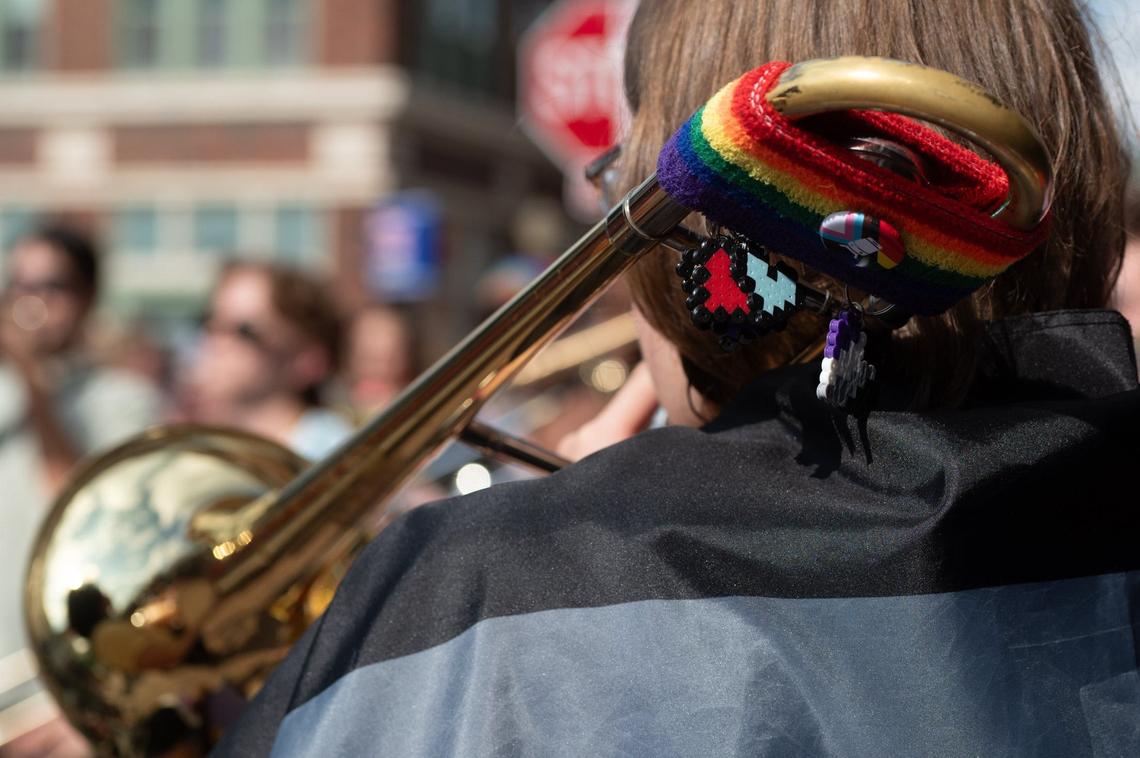 Charms and buttons are clipped to a rainbow wristband on a trombone during Sass-A-Brass’s performance at City Market Pride on Friday, June 21, 2024, in Kansas City.