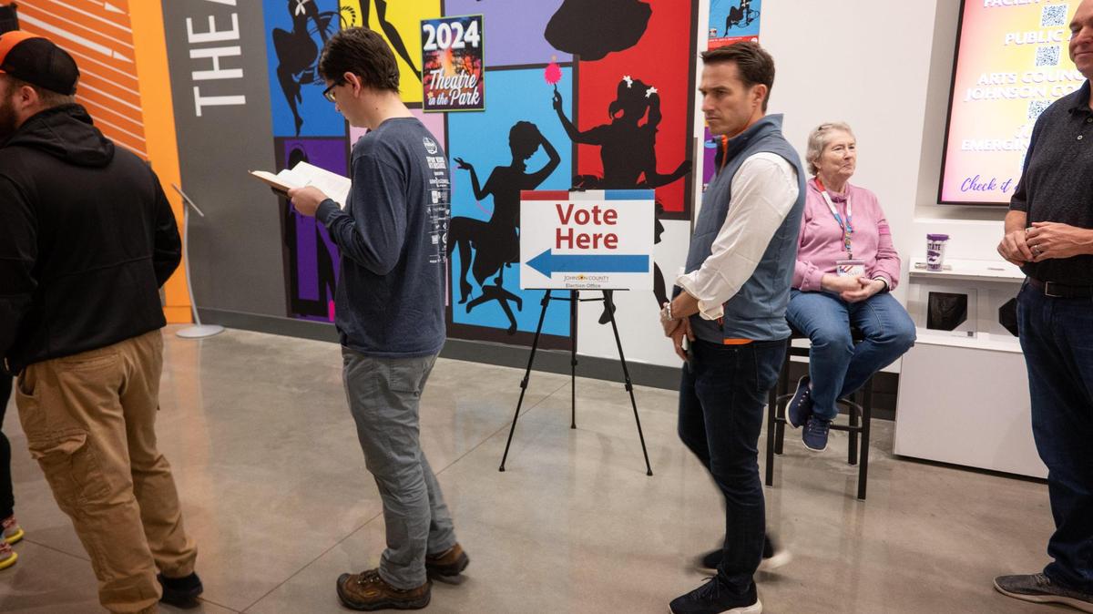 Voters line up to cast their ballots during advanced voting Monday, Nov. 4, at the Johnson County Arts and Heritage Center in Overland Park.