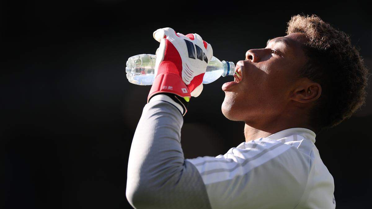 Man drinking sports drink.