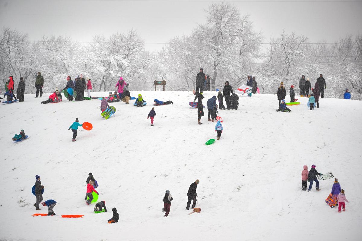 Sledders dotted a hill at Meadowbrook Park on Tuesday, Jan. 9, 2024, which was covered in snow after a winter storm dropped several inches of snow in the metro area including in Prairie Village.