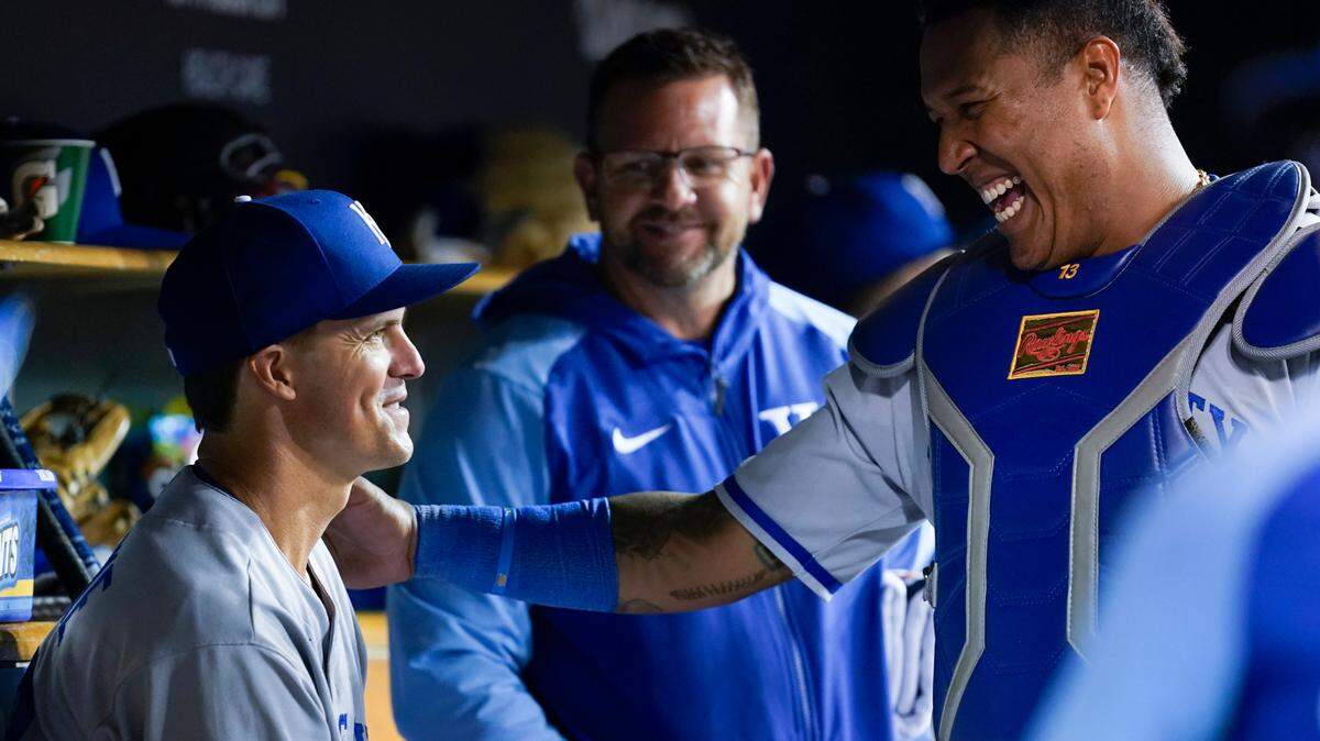 Kansas City Royals pitcher Zack Greinke, left, smiles with catcher Salvador Perez (13) after the seventh inning of a baseball game against the Detroit Tigers in Detroit, Tuesday, Sept. 27, 2022. (AP Photo/Paul Sancya)