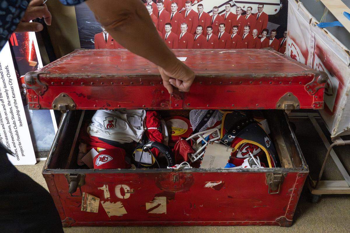 Chiefs historian Mike Davidson lifts the top of a trunk, revealing a collection of artifacts inside the team’s underground SubTropolis storage facility, located in the limestone caverns along the Missouri River north of downtown Kansas City.
