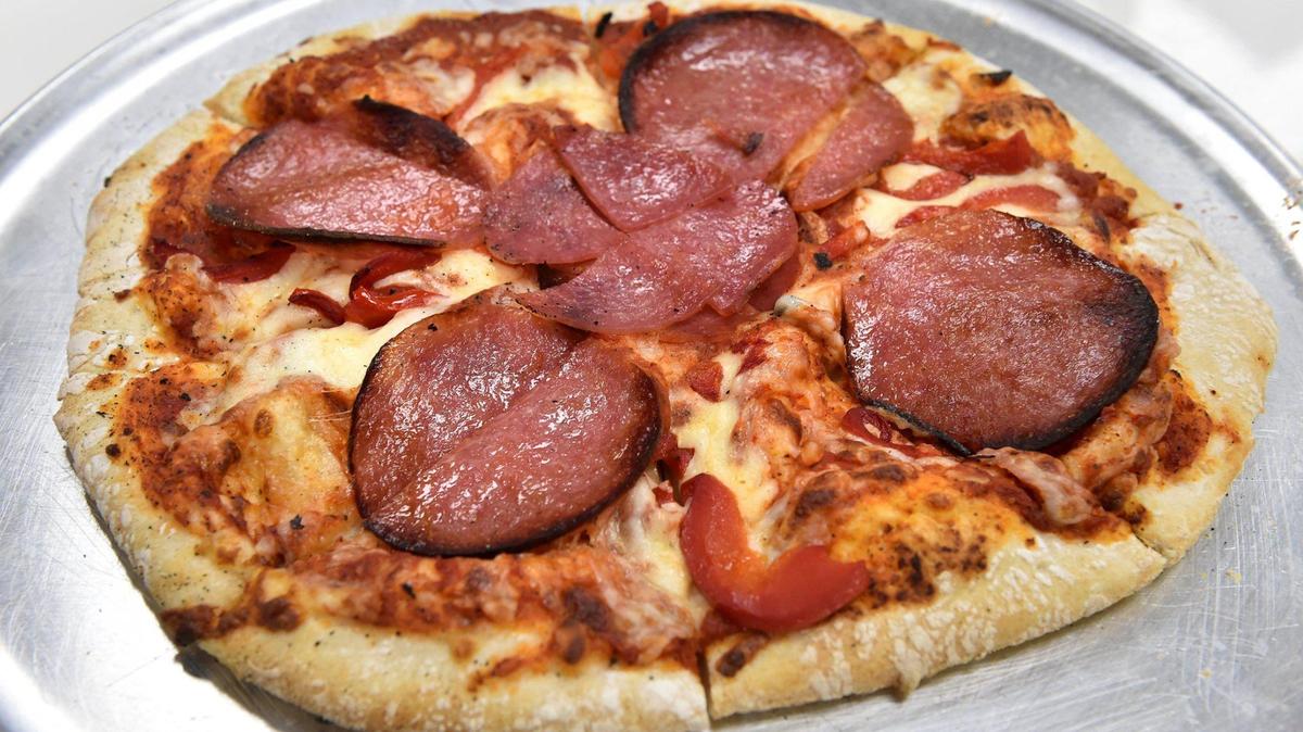 The Smoker pizza at Scimeca’s Ristorante in Shawnee has smoked salami, smoked olive tapenade, roasted red peppers, cheese and sauce.