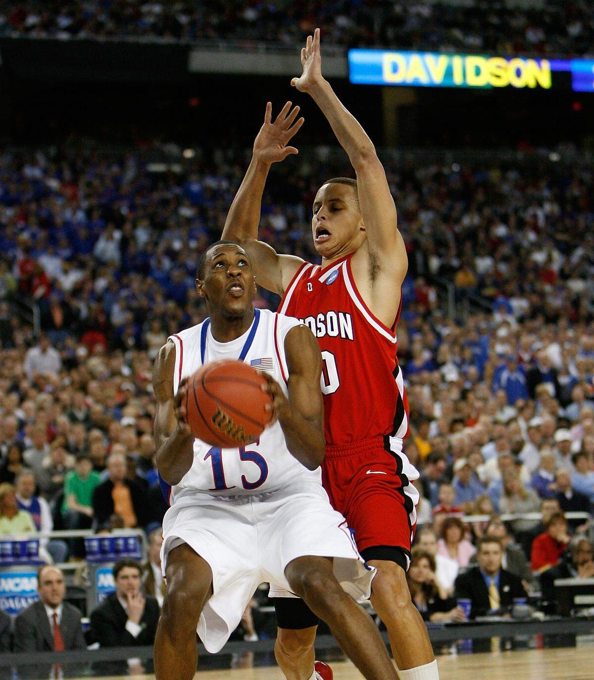 Mario Chalmers #15 of the Kansas Jayhawks drives against Stephen Curry #30 of the Davidson Wildcats during the Midwest Regional Final of the 2008 NCAA Division I Men's Basketball Tournament at Ford Field on March 30, 2008 in Detroit.
