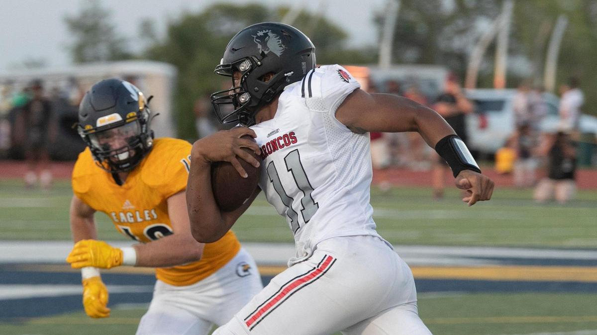 Lee’s Summit North quarterback Elijah Leonard tries to pick up some extra yardage against Liberty North during last week’s high school football season opener in Liberty.