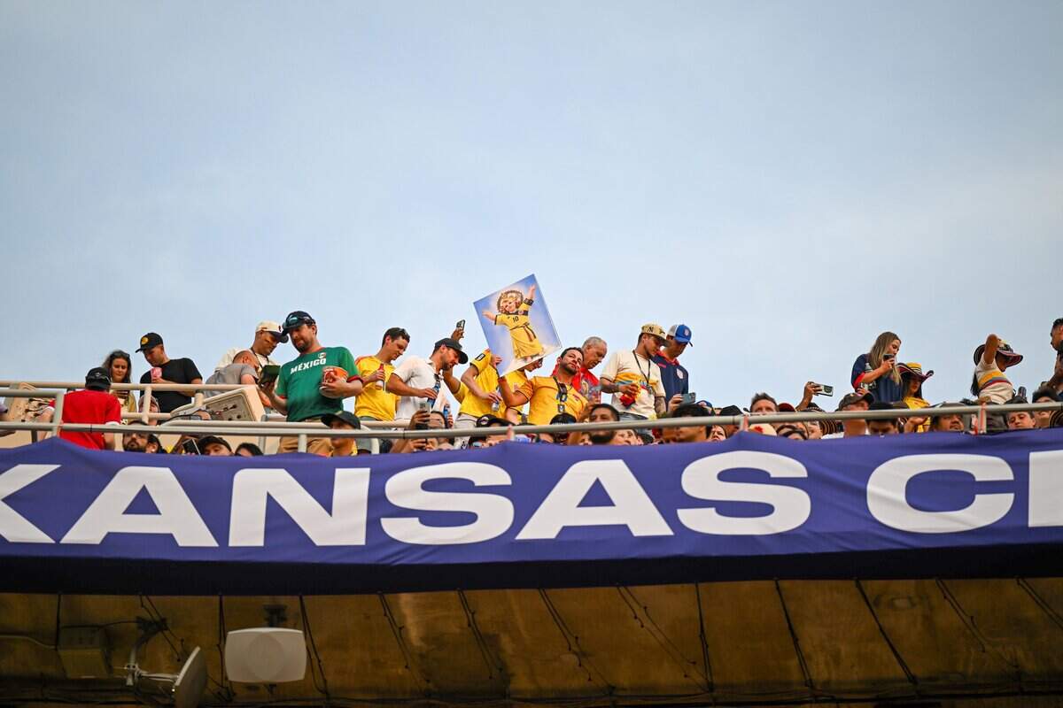 A Colombian fan holds up a poster with a religious icon-inspired version of Colombia midfielder James Rodríguez (10) at the Colombia vs. Ghana 2026 World Cup Round of 32 football match at Kansas City (Arrowhead) Stadium in Kansas City on Friday, July 3, 2026.