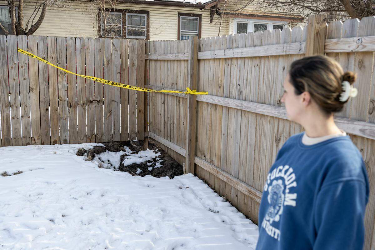 Cassandra Krul surveys the sinkhole in her backyard on Monday, Feb. 2, 2026, in Independence.