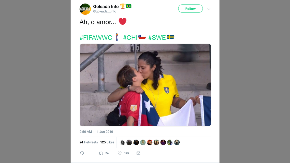 A Sweden supporter and Chile fan lock lips as their teams battle at the World Cup