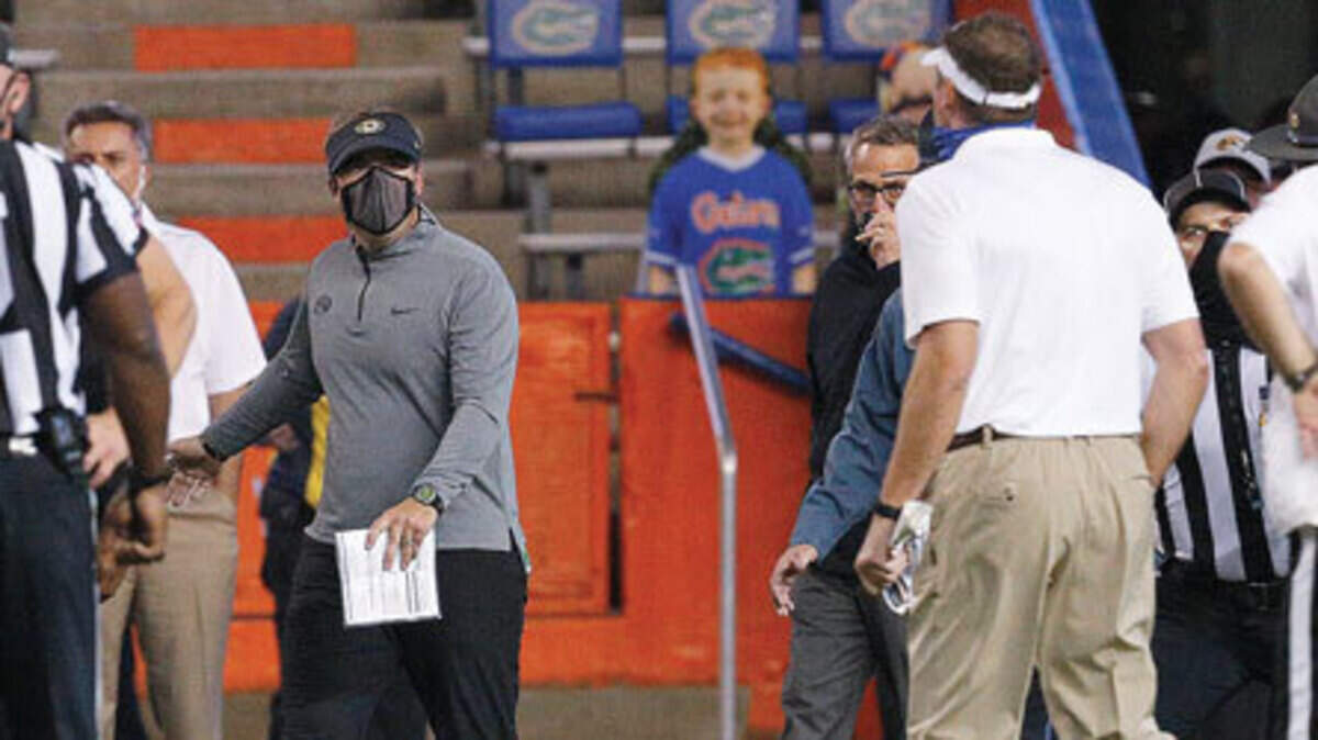 Missouri coach Eli Drinkwitz (left) and Florida coach Dan Mullen yell at each other after a fight broke out at the end of the first half of last year’s game in Gainesville, Fla.